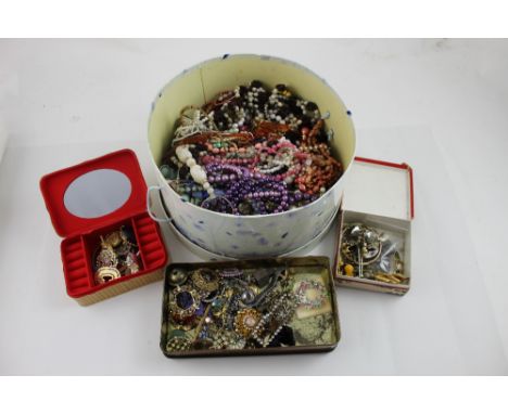 A large quantity of vintage and later costume jewellery to include various bead and chain necklaces, vintage brooches, bangle