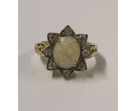 A 9ct yellow gold ladies' dress ring with oval opal and starburst of eight small diamonds, size N, approx 4.1g.