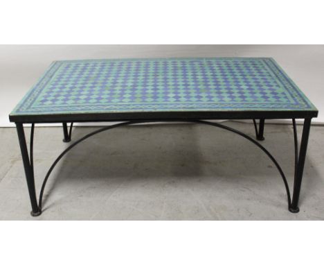 A modern coffee table with mosaic tile top panel, raised on black metal frame, height 48cm, length 120cm.