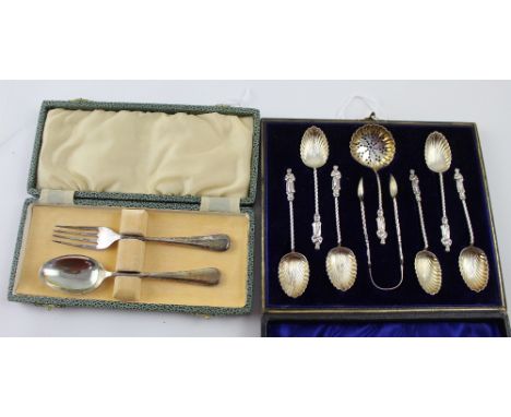 A Victorian cased set of six hallmarked silver Apostle spoons with shell bowls, a matching tea strainer and a pair of sugar n