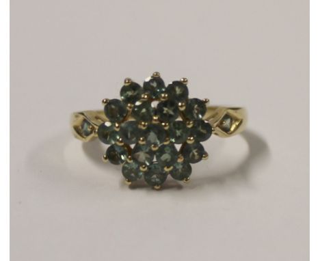 A 14ct yellow gold ladies' dress ring, floral-set with small green stones, size S, approx 3.4g