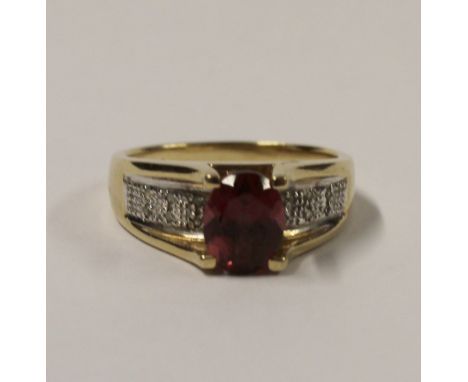 A 9ct yellow gold ladies' dress ring with pink oval tourmaline and pavé-set white stones to the shoulders, size R, approx 5.8