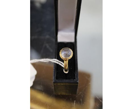 An early 17th century 24ct gold lover's ring, set with one faceted crystal stone and initials engraved to the under setting o