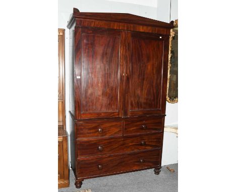 A 19th Century Mahogany Linen Press, complete with slides, 127cm by 59cm by 214cmCorners repaired in several places, frieze w