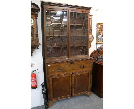 A George III Secretaire Bookcase, with glazed upper section crossbanded mahogany, 117cm by 47cm by 234cm