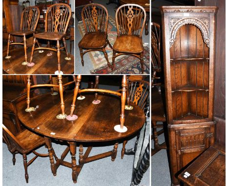 A Set of Four Siesta Elm Wheel Back Chairs, an oak gate leg dining table, and a floor standing corner cupboard.