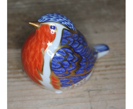 A Royal Crown Derby bird paperweight with gold stopper. 