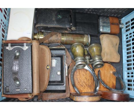 A box of collectables to include old French opera glasses, wooden bookends in shape of horseshoes, a 4 drawer brass telescope