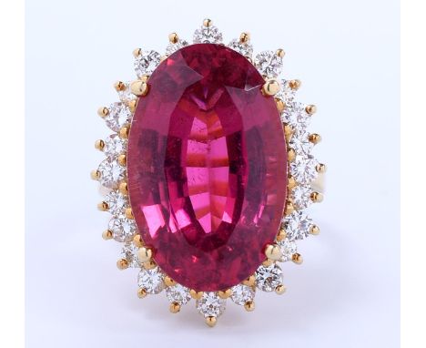 18 kt. Gouden ring, centraal bezet met een ovale gefacetteerde roze toermalijn van ca. 17,40 ct. in een entourage van briljan