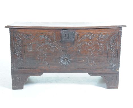A 17th Century six plank cofferThe rectangular plank hinged top above a front panel carved with a geometric design centred wi