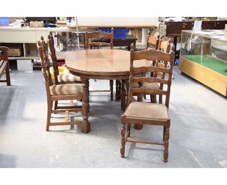 An oval oak French style dining table with six chairs,The table supported on ring turned and block supports along with six la