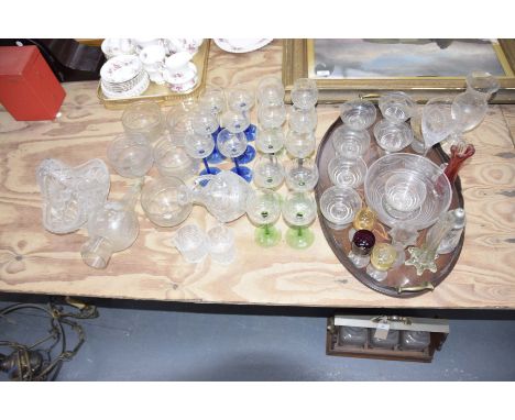 A large quantity coloured and cut glass, early 20th CenturyTo include decanter, vase, blue and clear glasses, multi colour gl