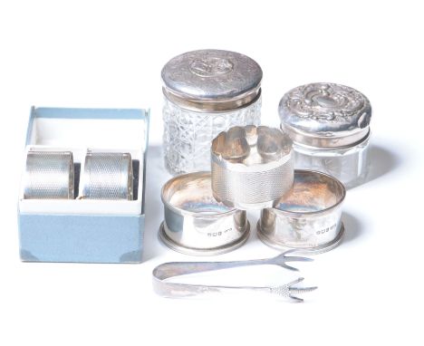 A silver pair of napkin ringsWith engine turned decoration, together with, three various silver napkin rings, two silver topp