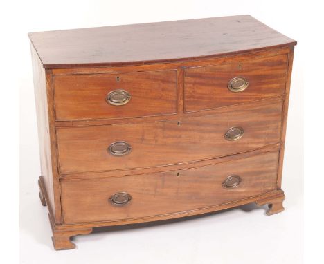 An early 19th Century mahogany bowfront chest of drawersWith two short and two long cockbeaded drawers each with oval back pl
