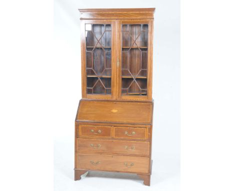 A Edwardian mahogany cross banded bureau bookcaseWith a crossbanded frieze above a pair of astragal glazed doors enclosing tw