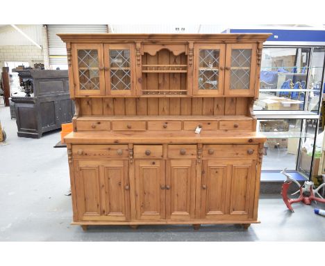 A modern pine kitchen dresserThe raised back with a moulded cornice above two central galleried shelves flanked by a pair of 