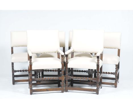 A set of six oak and cream leatherette 17th Century style dining chairsEach with padded back and padded arms over stuff over 