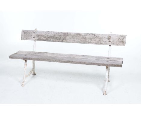 An early 20th Century hardwood and cast garden benchWith a single rail back above a two plank seat supported on cast naturali