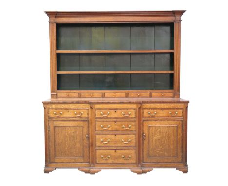 An exceptional George III oak and mahogany crossbanded breakfront dresserThe high back with a moulded stepped cornice above a