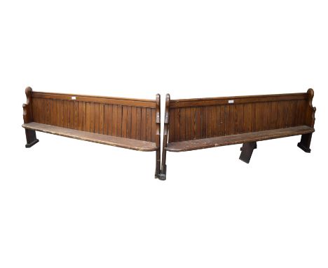 A near pair of late 19th early 20th Century pitch pine church pewsEach with a rear book trough and angled shaped bracket supp