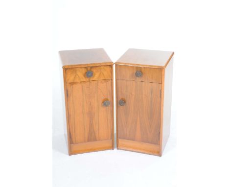 A pair of mid 20th Century walnut pot cupboardsEach with a single frieze drawer over a cupboard door with pierced button hand