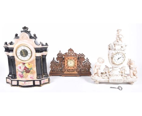 A collection of three mantel clocks, early to mid 20th Century,The first wooden fret work clock, 5cm cream dial with Arabic n