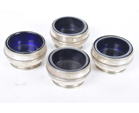 A set of four saltsOf circular form, with applied waist bands, with blue glass liners, by Walker & Hall, Birmingham 1944, wei