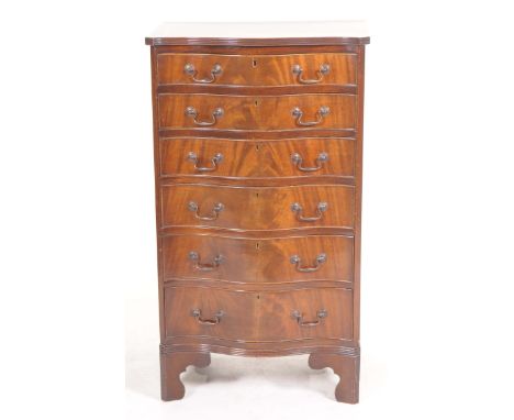 A good quality reproduction mahogany serpentine chestThe crossbanded serpentine top with a reeded border above six graduated 