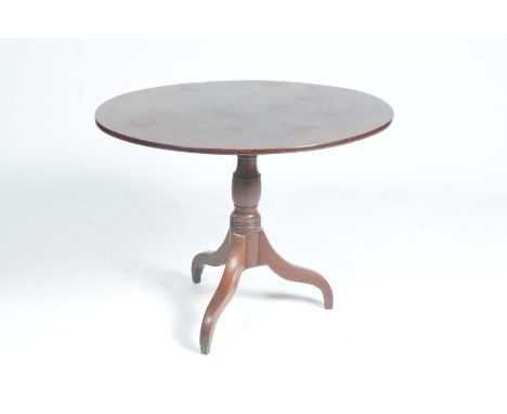 A Georgian oval mahogany tripod tableRaised on a ring turned baluster shaft with three downswept supports, 83x70cm.