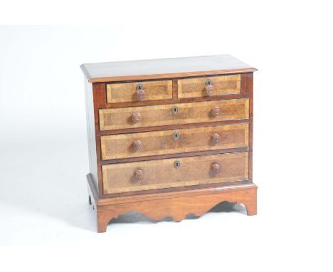 An 18th Century and later walnut and yew chest of drawersThe rectangular moulded top above two short and three long burr yew 