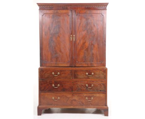 A George III mahogany linen pressWith a moulded dentil cornice above an arcaded frieze and two beaded panelled flame mahogany