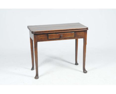 A Georgian oak folding tea tableThe rectangular folding top with rounded front corners above a single frieze drawer and butto