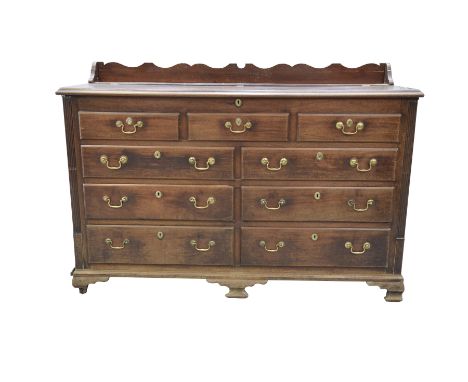 A George III mahogany Lancashire mule chestThe galleried top with a rectangular moulded hinged cover above an arrangement of 