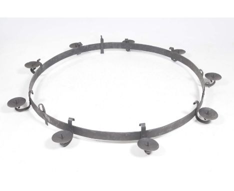 A large circular wrought iron hanging candle holderThe circular frame with nine circular saucer shaped candle holders, with l