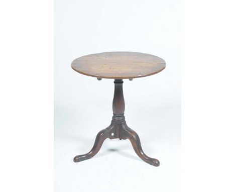 A George III oak tripod tableThe circular top raised on a ring turned baluster shaft with three downswept supports and pad fe
