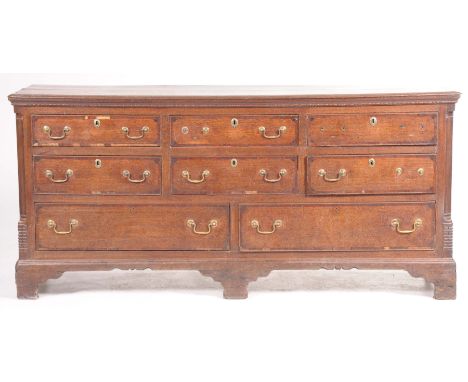 A George III oak and mahogany crossbanded dresser baseThe rectangular moulded top above an arrangement of six short drawers o
