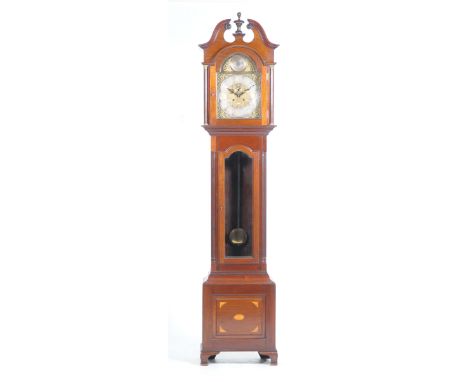 A fine Edwardian mahogany cased longcase clockWith a broken swan neck pediment and central urn shaped finial above a gilt met