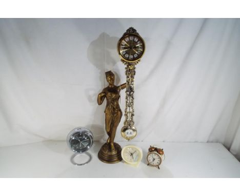 A lady figurine on a plinth holding a clock with a rhythm quartz movement, approx 58cm (h), a retro alarm clock by Coral, two