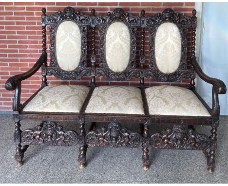 Heavily Carved&nbsp; settee in late 17th century style. With Cherub Decoration Sofa&nbsp; The triple-chair back with padded o