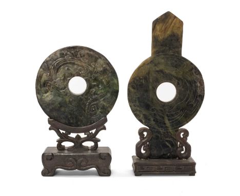 TWO CHINESE GREEN HARDSTONE ARCHAISTIC BI DISCS, one of conventional ring form, carved on one side in low relief with a chilo