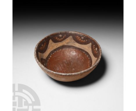 16th century A.D. or earlier. A ceramic bowl decorated on the interior with polychrome swags, dashes and scalloped motifs.  3