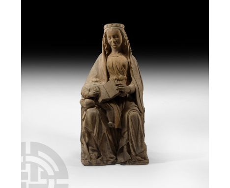 Loire Valley, France, circa 1500 A.D. A stone statue depicting the Virgin Mary seated with the (now acephalous) infant Christ