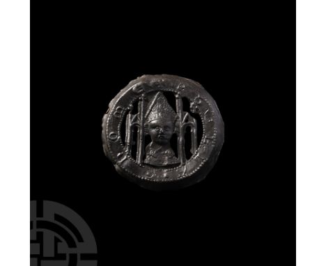 14th century A.D. A lead-alloy discoid pilgrim's badge with recessed rim, openwork facing bust of St. Thomas Becket with arca
