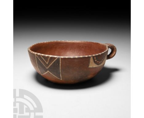15th-16th century A.D. or earlier. A polychrome ceramic vessel, possibly a cup or dish, with integral loop handle; decorative