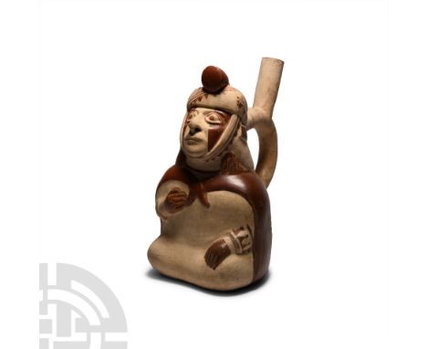 2nd-5th century A.D. A bichrome ceramic stirrup bottle in the form of a seated dignitary figure modelled with one hand restin