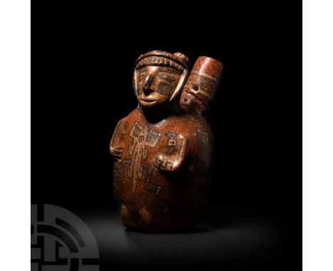 6th-10th century A.D. A polychrome figural ceramic bottle with cylindrical spout, human head modelled in-the-round wearing fa