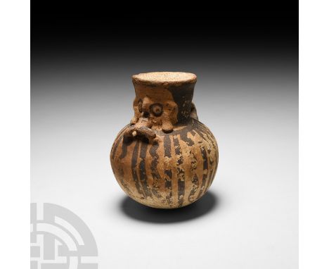 10th-15th century A.D. A bichrome ceramic juglet composed of a bulbous body, flared neck and rim and rounded base; stylised h