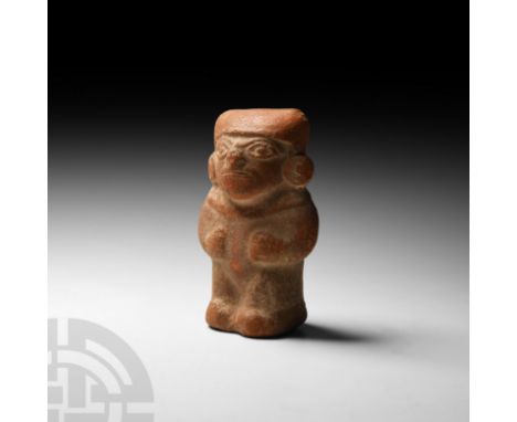 3rd-6th century A.D. A ceramic figure modelled standing naked, apart from an ornamental collar worn at the neck, a head cover