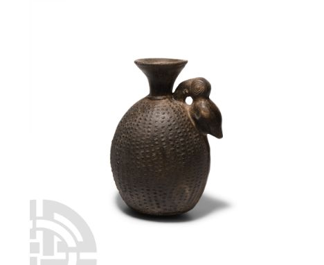 11th-15th century A.D. A black ware vessel with lentoid-section body and trumpet-style neck, handle formed as a stylised touc