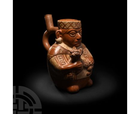 5th-7th century A.D. or earlier. A ceramic stirrup bottle with polychrome pigmentation, formed as a seated figure supporting 